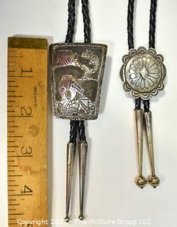 Two (2) Sterling Native American Artisan Made Bolo Ties.  One unmarked Sterling, One marked sterling and signed by Navajo artist Jereme Delgarito.