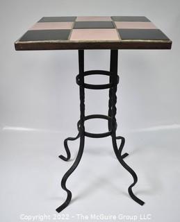 Vintage Wrought Iron Table with Pink and Black Tiled Top. Measures 21" tall and 13" square.