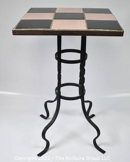 Vintage Wrought Iron Table with Pink and Black Tiled Top. Measures 21" tall and 13" square.