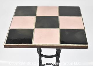 Vintage Wrought Iron Table with Pink and Black Tiled Top. Measures 21" tall and 13" square.