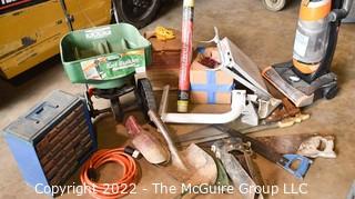 Collection of Misc. tools including Post Hole Diggers, Electric Vacuum, 3 crosscut saws, Extension Cord, Roll of Carpet Saving Film, Screw Case and Grass/Fertilizer Seeder.   