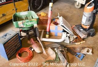 Collection of Misc. tools including Post Hole Diggers, Electric Vacuum, 3 crosscut saws, Extension Cord, Roll of Carpet Saving Film, Screw Case and Grass/Fertilizer Seeder.   