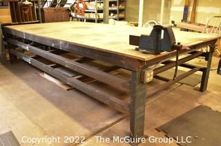 6' x 12' x 31"T Large (and heavy) steel work table with two shelves below. Top is covered with 1.5" particle board.  Encourage inspection, Tuesday, April 26, 2-4pm.  Late pickup - between 2-3pm. Forklift can be used to assist loading.  