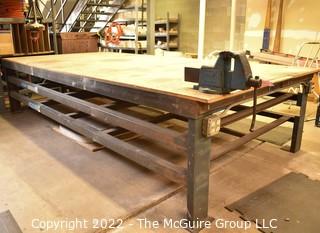 6' x 12' x 31"T Large (and heavy) steel work table with two shelves below. Top is covered with 1.5" particle board.  Encourage inspection, Tuesday, April 26, 2-4pm.  Late pickup - between 2-3pm. Forklift can be used to assist loading.  