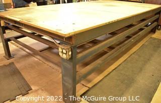 6' x 12' x 31"T Large (and heavy) steel work table with two shelves below. Top is covered with 1.5" particle board.  Encourage inspection, Tuesday, April 26, 2-4pm.  Late pickup - between 2-3pm. Forklift can be used to assist loading.  