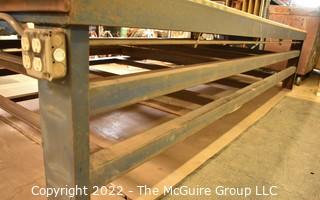 6' x 12' x 31"T Large (and heavy) steel work table with two shelves below. Top is covered with 1.5" particle board.  Encourage inspection, Tuesday, April 26, 2-4pm.  Late pickup - between 2-3pm. Forklift can be used to assist loading.  