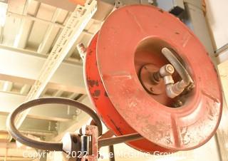 Pneumatic commercial hose reel bolted to I-beam.  Buyer to disassemble. 