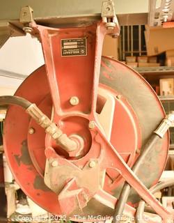 Pneumatic commercial hose reel bolted to I-beam.  Buyer to disassemble. 