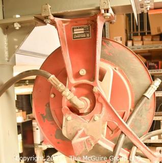 Pneumatic commercial hose reel bolted to I-beam.  Buyer to disassemble. 