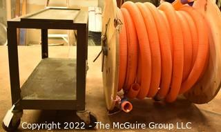 Approximately 58' Orange Hose on Wooden Reel and small metal two shelf cart on casters. 