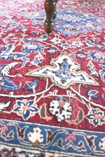 Vintage Isfahan Signed Hand-Knotted Wool Rug with Lotus Blossom Design on Red Ground with Blue Border. Signed by Artist on Border Edge. Some wear in the center. 118" x 159".