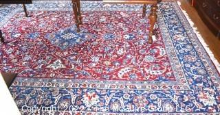 Vintage Isfahan Signed Hand-Knotted Wool Rug with Lotus Blossom Design on Red Ground with Blue Border. Signed by Artist on Border Edge. Some wear in the center. 118" x 159".