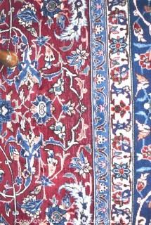 Vintage Isfahan Signed Hand-Knotted Wool Rug with Lotus Blossom Design on Red Ground with Blue Border. Signed by Artist on Border Edge. Some wear in the center. 118" x 159".