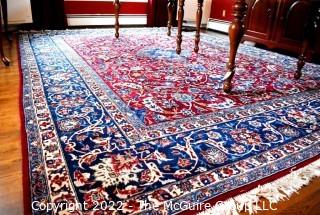 Vintage Isfahan Signed Hand-Knotted Wool Rug with Lotus Blossom Design on Red Ground with Blue Border. Signed by Artist on Border Edge. Some wear in the center. 118" x 159".