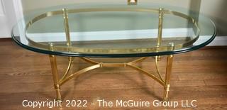 Contemporary Oval Brass and Glass Coffee Table.  46ʺW × 26ʺD × 16ʺH
