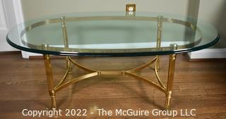 Contemporary Oval Brass and Glass Coffee Table.  46ʺW × 26ʺD × 16ʺH
