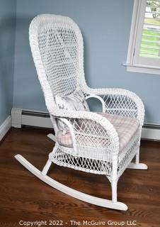 White Painted Wicker Rocking Chair with Cushion and Throw Pillow.