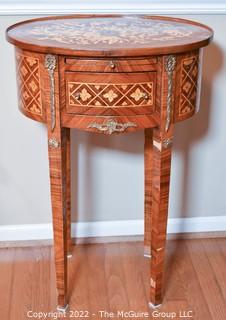 Louis XVI Style Marquetry Side Table with Tulip Wood Inlay, Metal Decoration, Gilt Embossed Florentine Leather Lined Pull out Tray and Drawer.   One of pair being offered. Some veneer loss, pieces included.  14" x 21" x 31"T