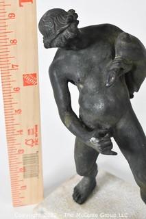 Vintage Bronze "Satyr with a Wineskin" Sculpture After the Sculpture From the House of the Centenary, Pompeii. The statuette, mounted on a base in travertine marble, measures 10" tall, 7" wide and 4" deep.