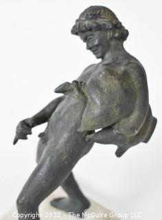 Vintage Bronze "Satyr with a Wineskin" Sculpture After the Sculpture From the House of the Centenary, Pompeii. The statuette, mounted on a base in travertine marble, measures 10" tall, 7" wide and 4" deep.