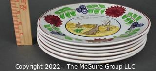 Collection of Hand-Painted Porcelain Plates in Various Designs.