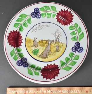 Collection of Hand-Painted Porcelain Plates in Various Designs.