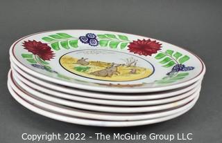 Collection of Hand-Painted Porcelain Plates in Various Designs.