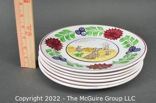 Collection of Hand-Painted Porcelain Plates in Various Designs.