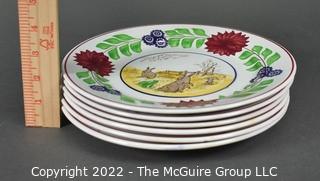 Collection of Hand-Painted Porcelain Plates in Various Designs.