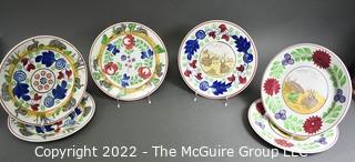 Collection of Hand-Painted Porcelain Plates in Various Designs.