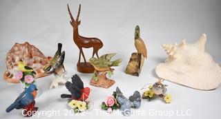 Collection of Decorative Collectibles Including Conch Shells and Porcelain Birds.