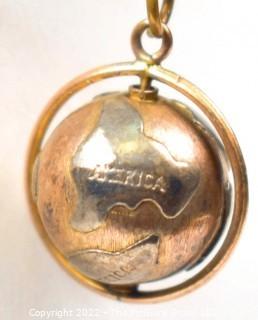 Vintage 14kt Yellow Gold Pierced and Articulated World Globe Charm or Pendant. 2.1 grams.