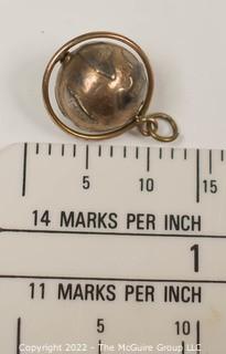 Vintage 14kt Yellow Gold Pierced and Articulated World Globe Charm or Pendant. 2.1 grams.