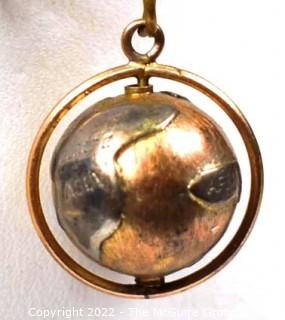 Vintage 14kt Yellow Gold Pierced and Articulated World Globe Charm or Pendant. 2.1 grams.