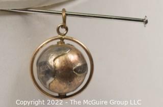 Vintage 14kt Yellow Gold Pierced and Articulated World Globe Charm or Pendant. 2.1 grams.