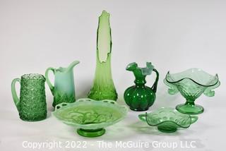 Seven (7) Green Fenton Glass Serving and Decorative Pieces Including Pitchers, Vases and Pedestal Bowls.