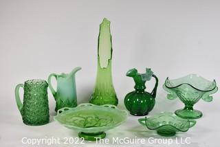 Seven (7) Green Fenton Glass Serving and Decorative Pieces Including Pitchers, Vases and Pedestal Bowls.