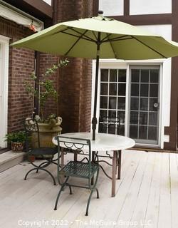 Outdoor Garden Table with Three (3) Cast Iron Chairs and Umbrella.   46" diameter.