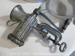 Collection of kitchenware including vintage meat grinder, waffle iron and KitchenAid pot