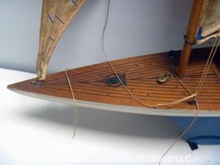 Two vintage wooden sail boats, unmarked, cloth sails and rigging deteriorating