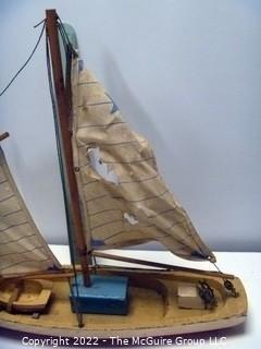 Two vintage wooden sail boats, unmarked, cloth sails and rigging deteriorating