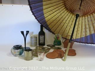 Collection including leather coasters, candles, snow globe, and a large parasol