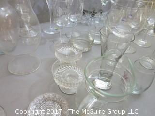 Collection of glassware including (2) Waterford crystal stems, hurricane shade and assorted stemware 