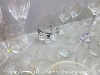 Collection of glassware including (2) Waterford crystal stems, hurricane shade and assorted stemware 