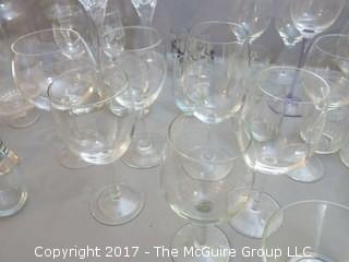 Collection of glassware including (2) Waterford crystal stems, hurricane shade and assorted stemware 