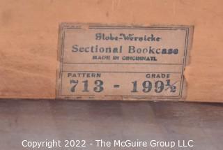 Two-section Globe Wernicke Two-Stack Glass Front Barrister Bookcase with top and base. Separates into two stackable units. 11" x 34" x 41".