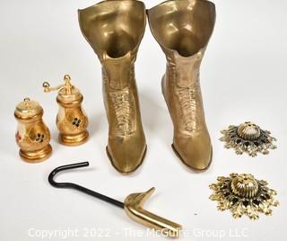 Selection of brass-like metal items: boot vases, salt & pepper, escutcheons, duck head hanger