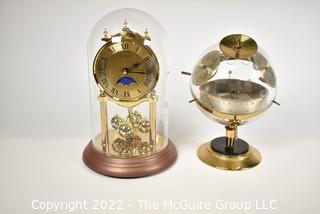 Pair of table display items: clock under glass dome and Barometer/Humidity gauges in a globe