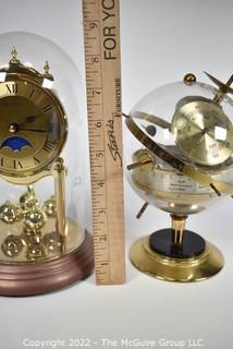 Pair of table display items: clock under glass dome and Barometer/Humidity gauges in a globe