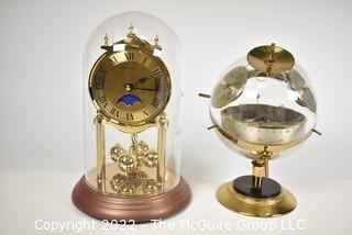 Pair of table display items: clock under glass dome and Barometer/Humidity gauges in a globe